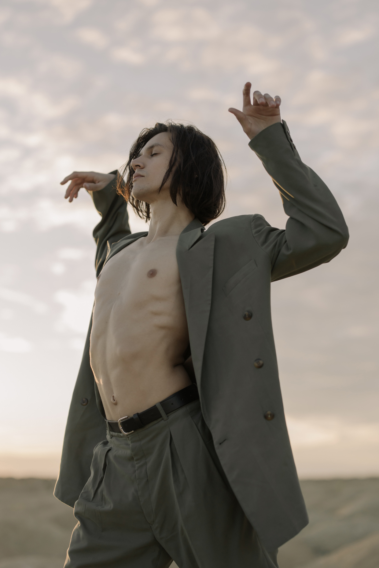 Woman in Brown Coat Standing Under White Clouds